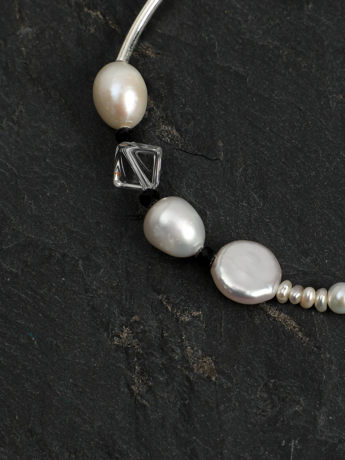 Close-up detail of baroque pearls, black tourmaline, and clear quartz on the Psyours Pure Radiance bracelet