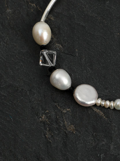 Close-up detail of baroque pearls, black tourmaline, and clear quartz on the Psyours Pure Radiance bracelet