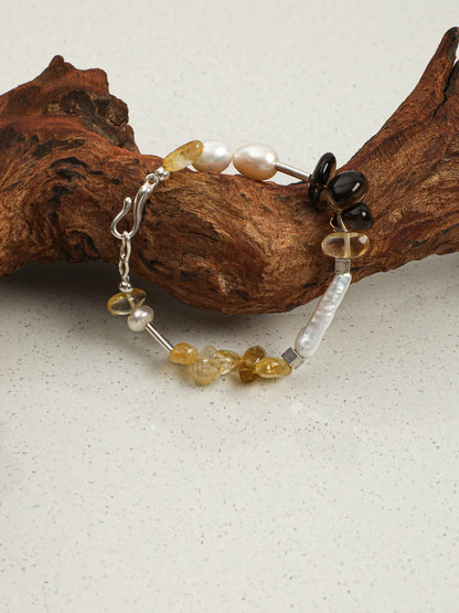 Sunlit Amber pearl and citrine smoky quartz bracelet on a light background