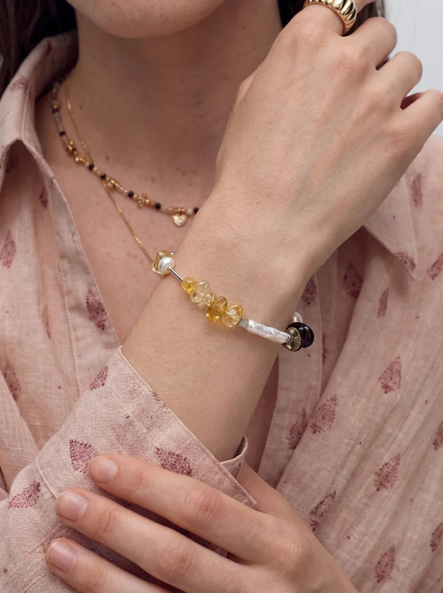 Illustrative styling image of the Sunlit Amber bracelet worn on the wrist
