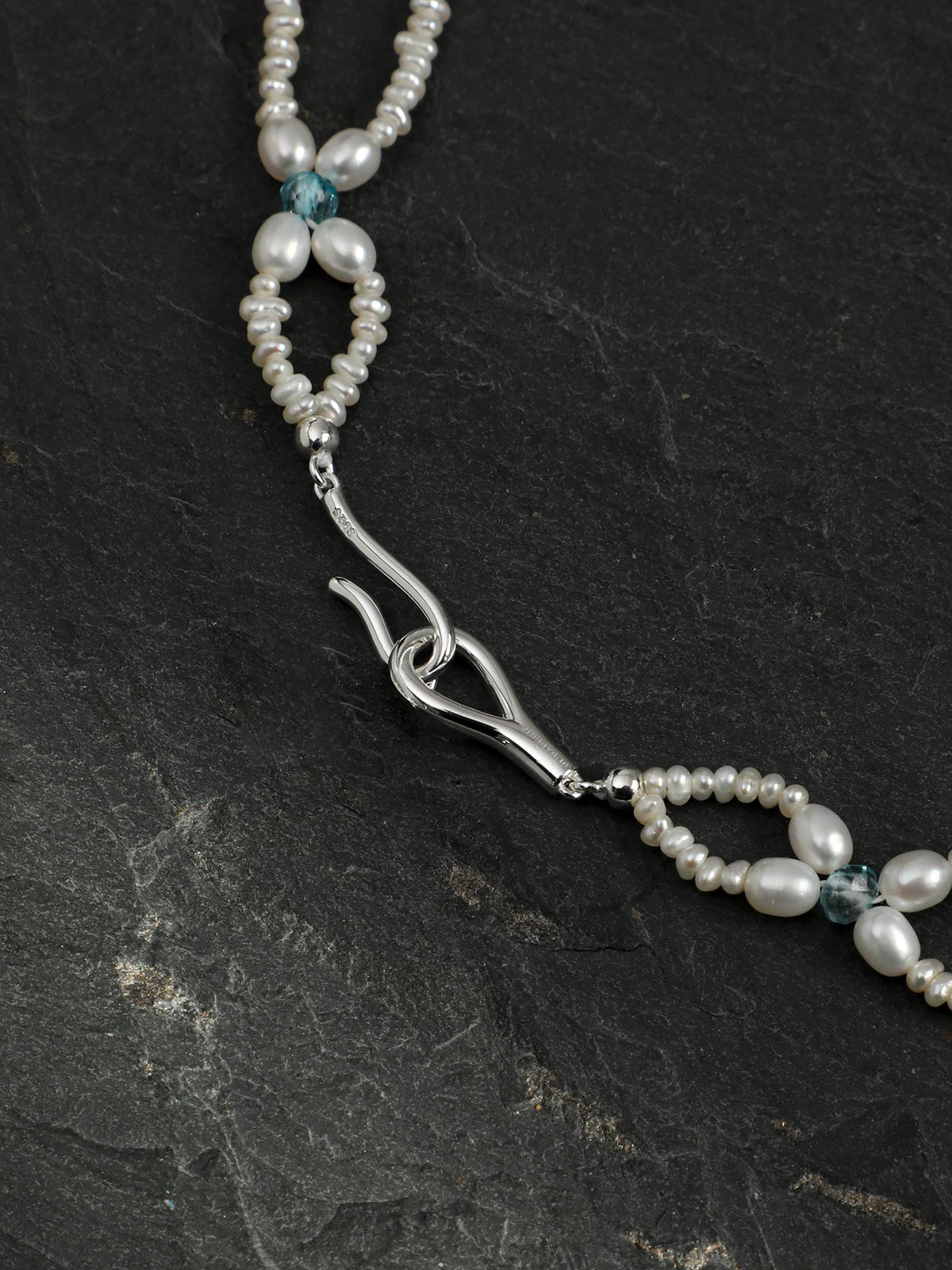 Woven Waves pearl lace necklace with multi-gemstone accents on a light background