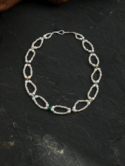 Full-length view of the Woven Waves pearl lace necklace