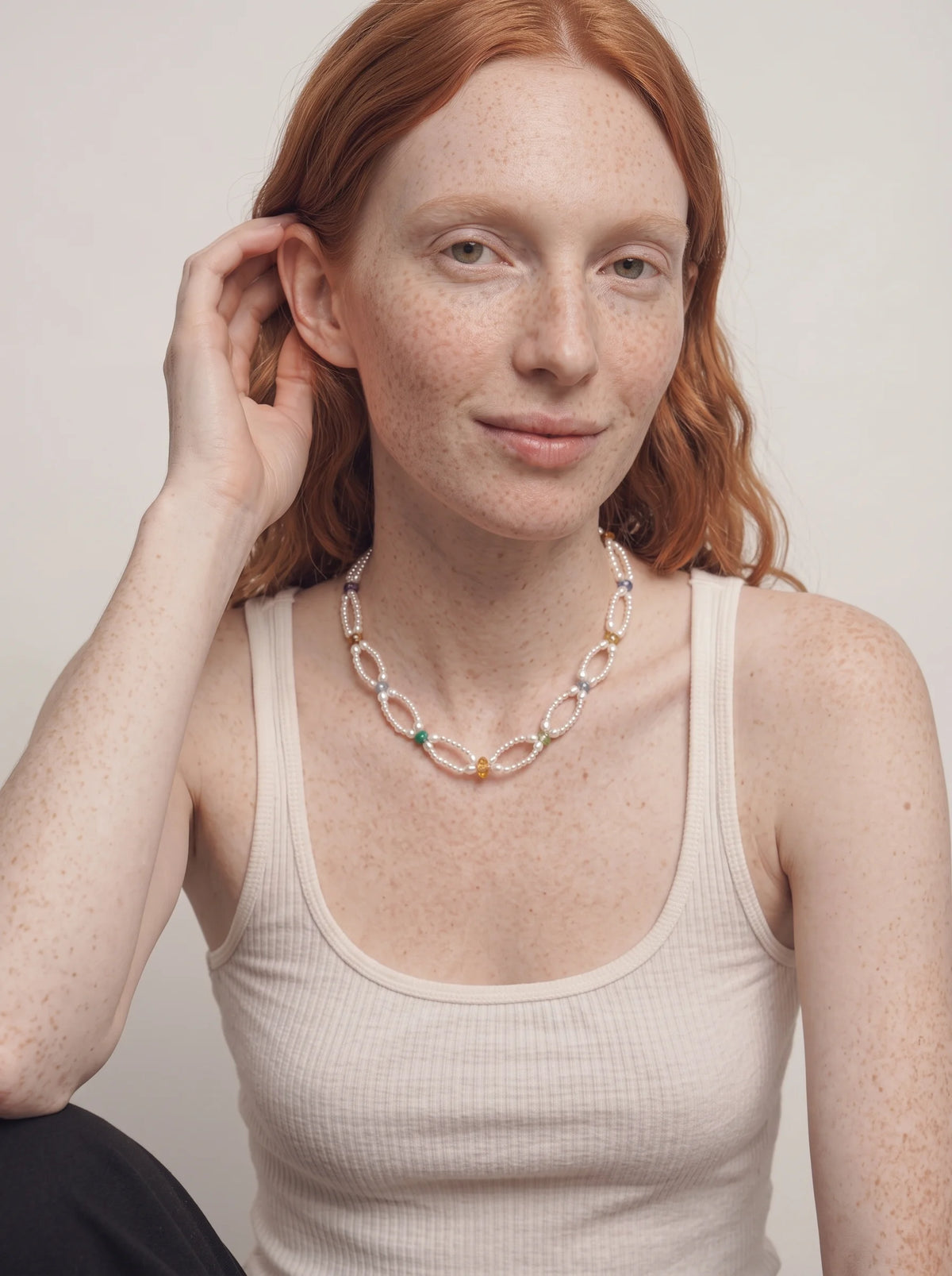 Illustrative styling image of the Woven Waves necklace worn at the collarbone